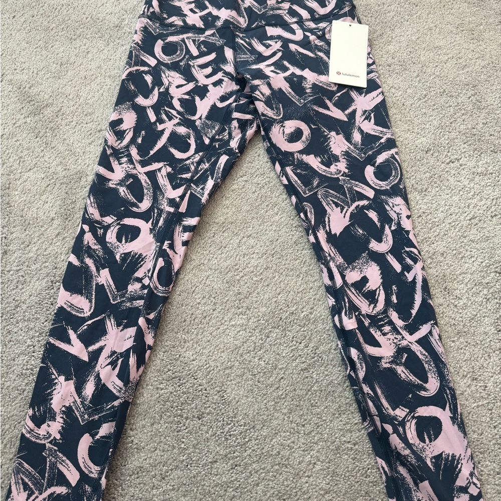 NWT Lulu Lemon size 10 Lulu logo print in pink and black.
Smoke free home.